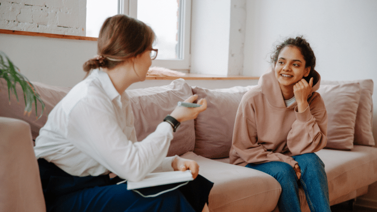 Two women on a coach doing therapy